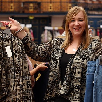 Model holding up various garments and smiling