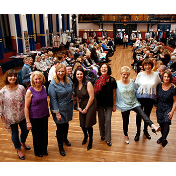 8 models smiling and posing at camera